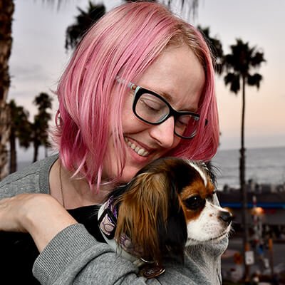 Shay DuBois, LCSW, trauma therapist, smiling with her dog Luna