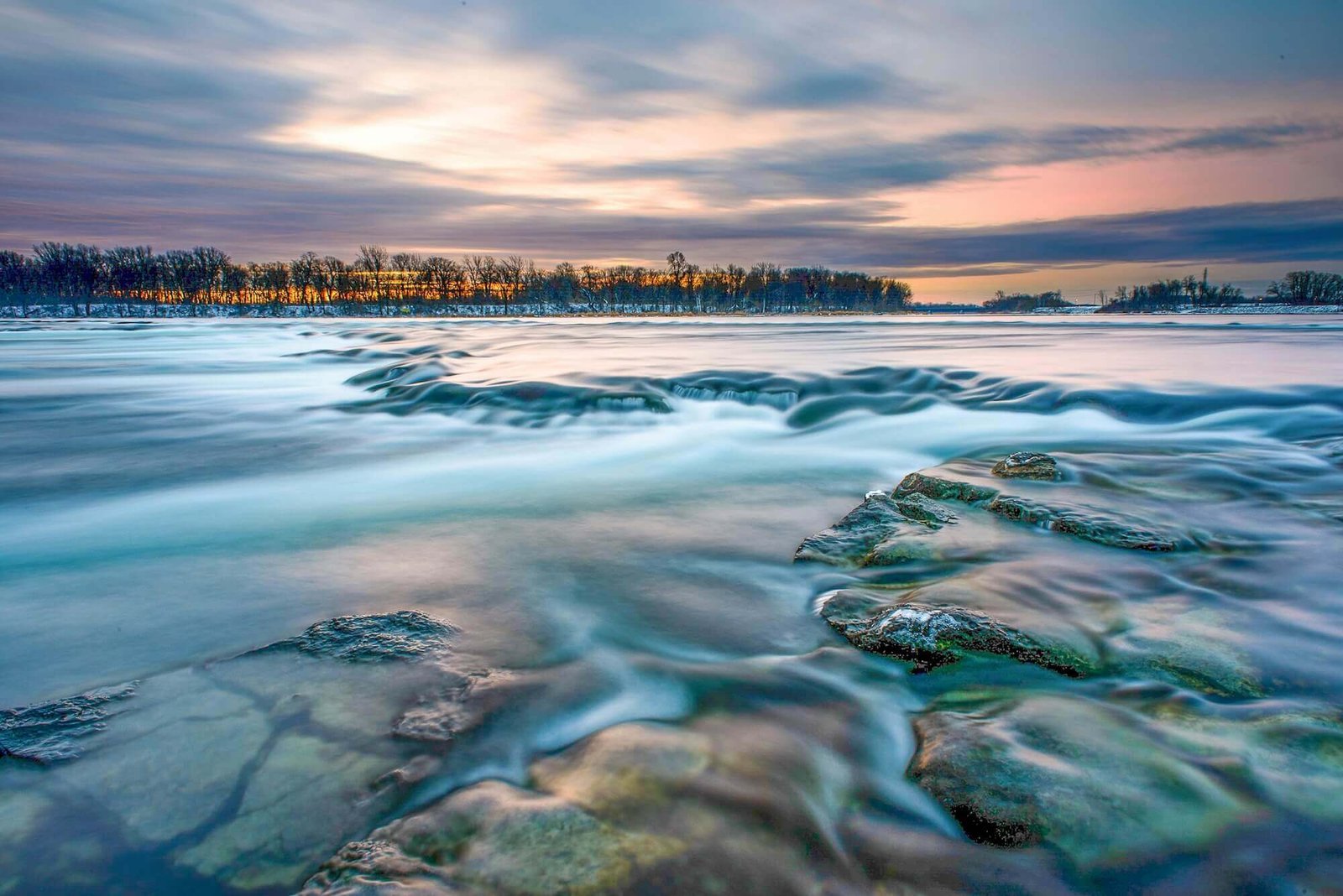 Tranquil river scene at sunset, reflecting the peace achievable through somatic therapy.