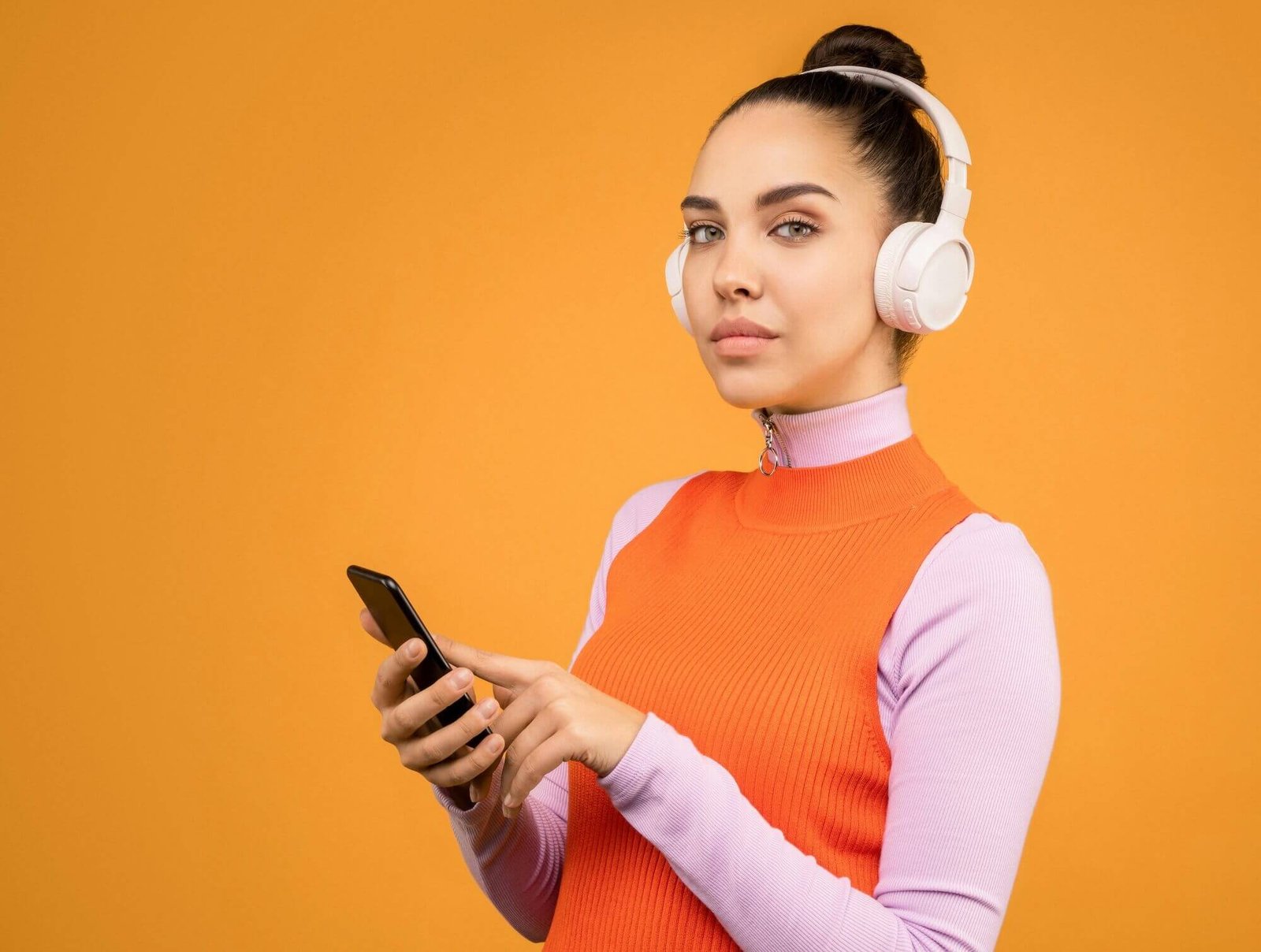 Woman listening to podcasts on headphones, using smartphone to anxiety and trauma podcasts