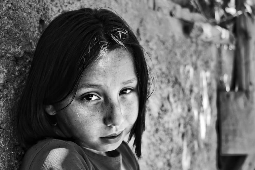 A young girl's pensive face, reflecting potential trauma from childhood sexual abuse and its impact on attachment.