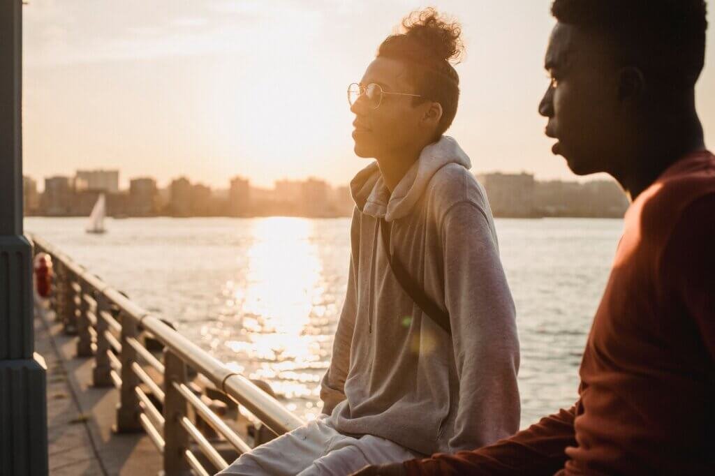 Friends relaxing by the water at sunset β attachment trauma therapy in San Diego